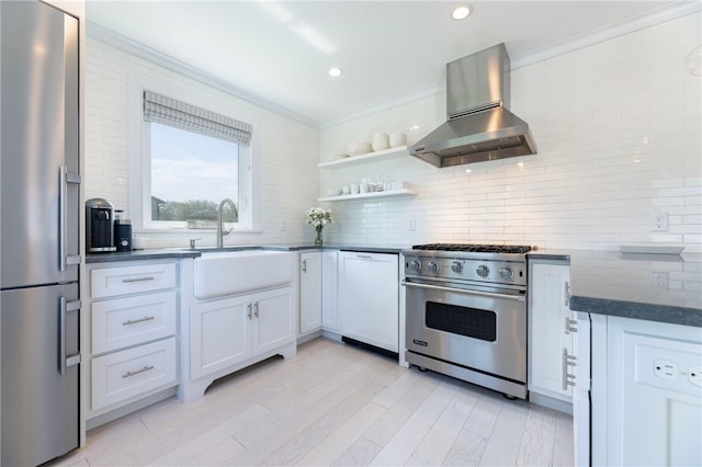 21 Overlook Ave, Charlestown, RI 02813 - kitchen featuring appliances with stainless steel finishes, wall chimney exhaust hood, dark countertops, backsplash, and recessed lighting