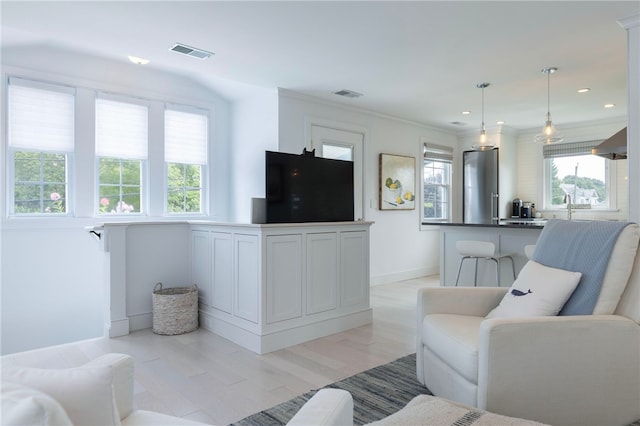 21 Overlook Ave, Charlestown, RI 02813 - living area featuring light wood-type flooring, recessed lighting, and crown molding