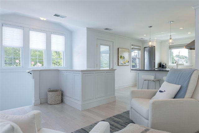 21 Overlook Ave, Charlestown, RI 02813 - living room featuring light wood-style floors, recessed lighting, and ornamental molding