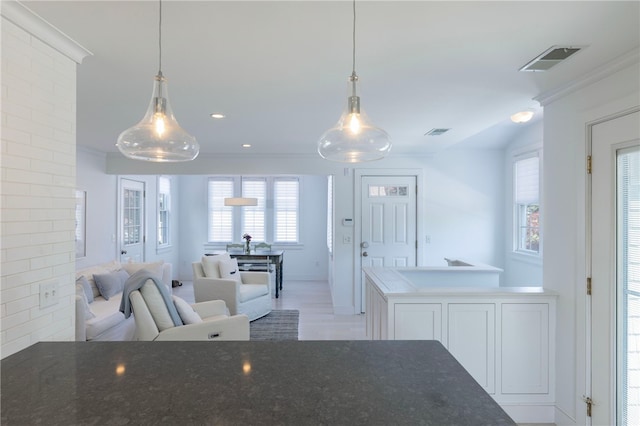 21 Overlook Ave, Charlestown, RI 02813 - kitchen featuring open floor plan, pendant lighting, ornamental molding, and light wood-style floors