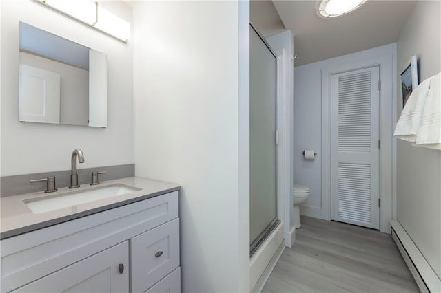 21 Overlook Ave, Charlestown, RI 02813 - full bathroom featuring a baseboard radiator, vanity, wood finished floors, and a closet