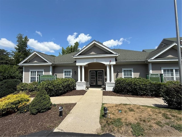 106 Mill St Unit 102, Woonsocket, RI 02895 - view of front of house featuring french doors, roof with shingles, and covered porch