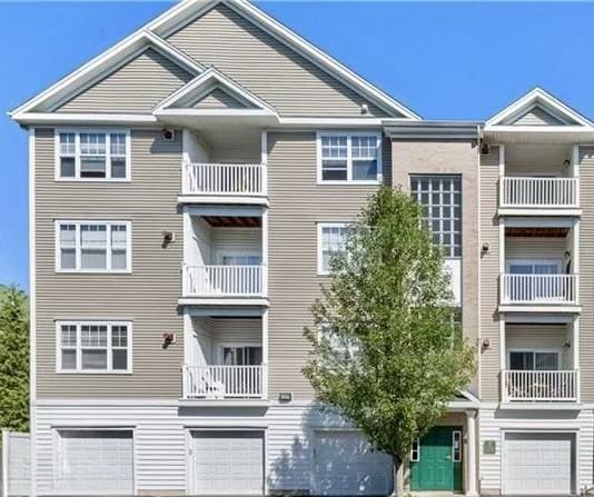 106 Mill St Unit 102, Woonsocket, RI 02895 - view of building exterior with a garage