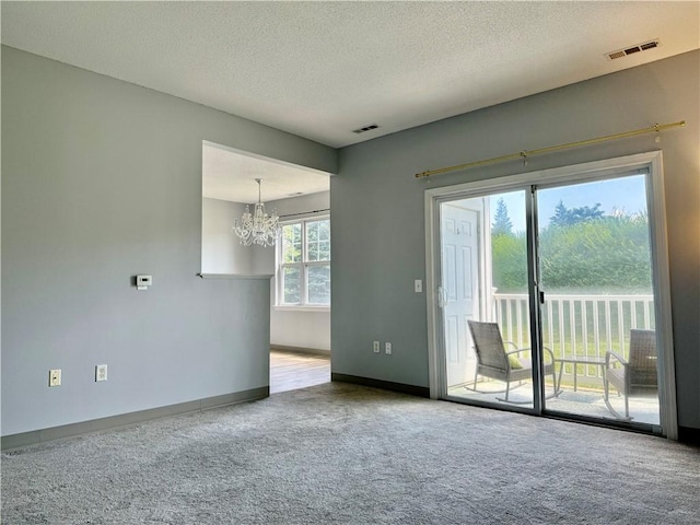 106 Mill St Unit 102, Woonsocket, RI 02895 - empty room featuring a chandelier, carpet floors, and a textured ceiling