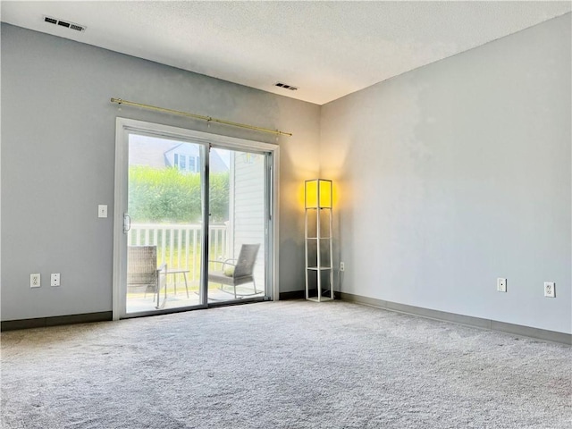 106 Mill St Unit 102, Woonsocket, RI 02895 - carpeted spare room with a textured ceiling and baseboards