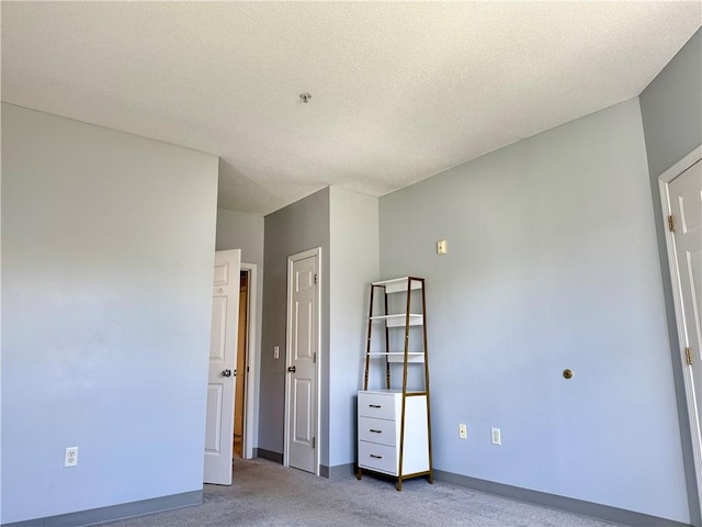 106 Mill St Unit 102, Woonsocket, RI 02895 - unfurnished bedroom featuring light carpet and a textured ceiling