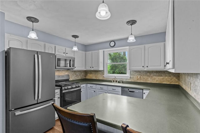43 Peckham Pl, Bristol, RI 02809 - kitchen featuring stainless steel appliances, white cabinets, and decorative backsplash