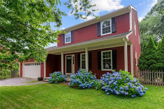 43 Peckham Pl, Bristol, RI 02809 - traditional home with a porch, an attached garage, and asphalt driveway