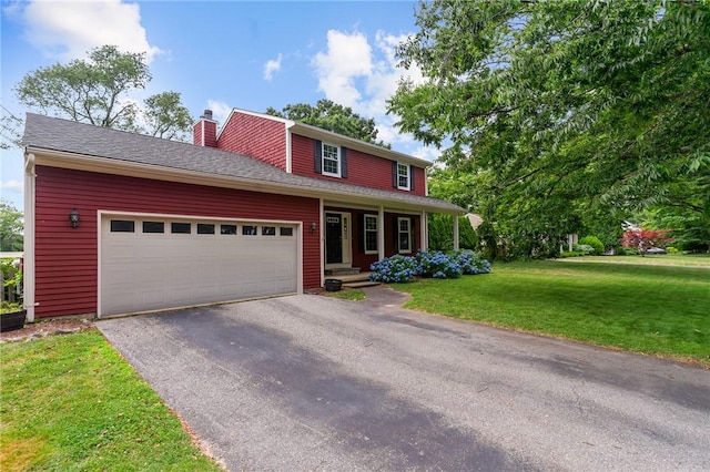 43 Peckham Pl, Bristol, RI 02809 - traditional home featuring a chimney, asphalt driveway, a front lawn, an attached garage, and covered porch