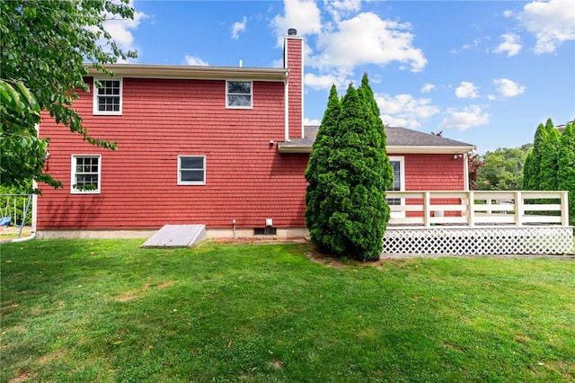 43 Peckham Pl, Bristol, RI 02809 - back of property featuring a chimney, a yard, and a deck