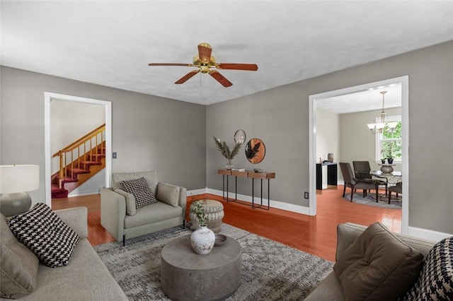 43 Peckham Pl, Bristol, RI 02809 - living room featuring wood finished floors, stairs, a ceiling fan, and a chandelier