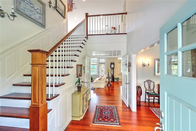 25 Brayton Point Rd, Westport, MA 02790 - entrance foyer featuring a decorative wall, stairs, wood finished floors, wainscoting, and a towering ceiling