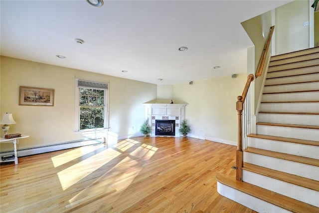 25 Brayton Point Rd, Westport, MA 02790 - unfurnished living room with baseboard heating, a premium fireplace, stairs, light wood-style floors, and recessed lighting