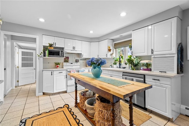 17 Golini Dr, Johnston, RI 02919 - kitchen featuring appliances with stainless steel finishes, under cabinet range hood, light countertops, white cabinetry, and decorative backsplash