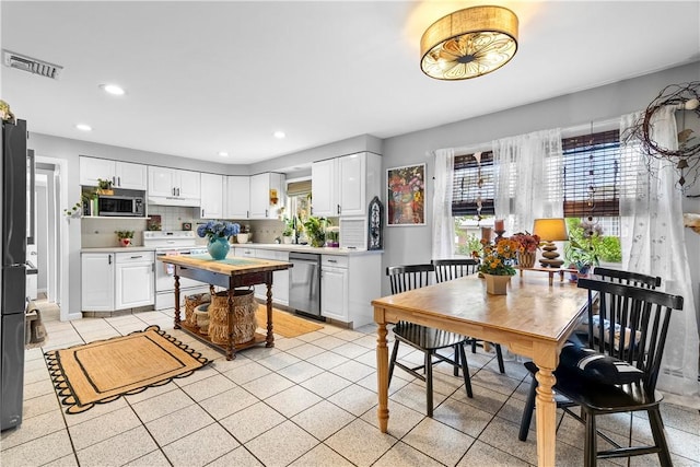 17 Golini Dr, Johnston, RI 02919 - kitchen featuring stainless steel appliances, light countertops, white cabinetry, recessed lighting, and light tile patterned floors