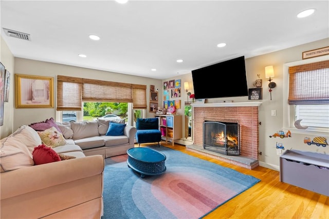 17 Golini Dr, Johnston, RI 02919 - living room featuring wood finished floors, recessed lighting, and a brick fireplace