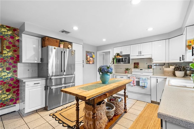 17 Golini Dr, Johnston, RI 02919 - kitchen with appliances with stainless steel finishes, under cabinet range hood, white cabinets, a baseboard heating unit, and recessed lighting