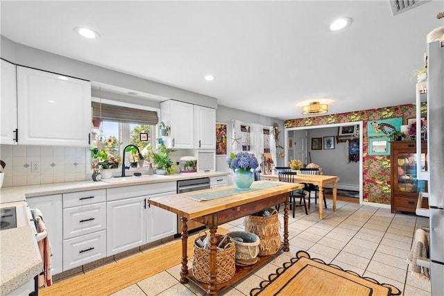 17 Golini Dr, Johnston, RI 02919 - kitchen featuring stove, light countertops, dishwasher, light tile patterned floors, and white cabinetry