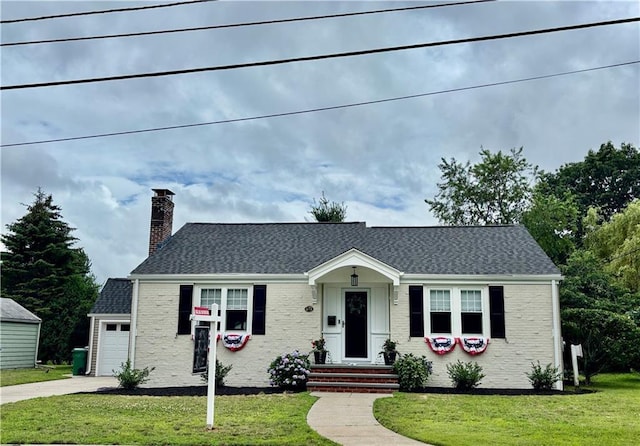 72 Audubon Rd, Warwick, RI 02888 - view of front of home featuring brick siding, a chimney, a front lawn, concrete driveway, and roof with shingles