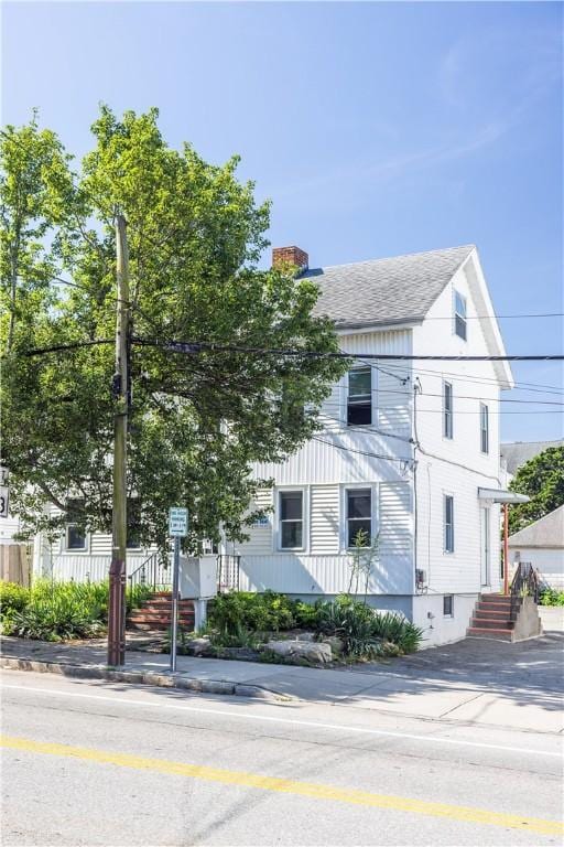 89 Warren Ave, East Providence, RI 02914 - view of front of property featuring a chimney and a shingled roof