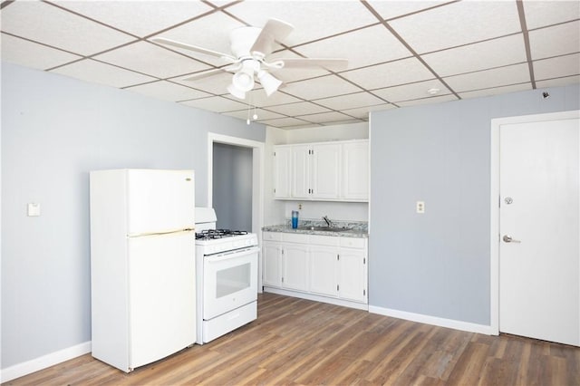 89 Warren Ave, East Providence, RI 02914 - kitchen with white appliances, white cabinets, a paneled ceiling, light wood-style flooring, and a ceiling fan