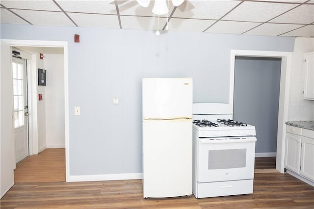 89 Warren Ave, East Providence, RI 02914 - kitchen with white appliances, a drop ceiling, white cabinets, and wood finished floors