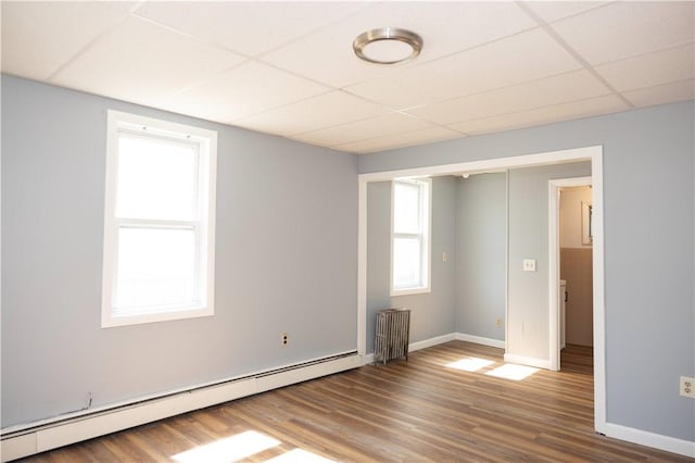 89 Warren Ave, East Providence, RI 02914 - unfurnished room featuring radiator heating unit, a baseboard heating unit, a paneled ceiling, and wood finished floors