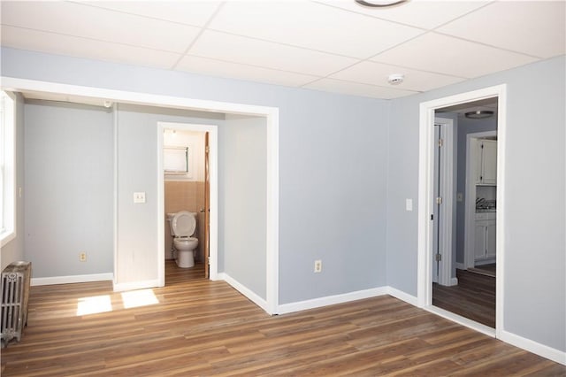 89 Warren Ave, East Providence, RI 02914 - spare room featuring radiator heating unit, a paneled ceiling, wood finished floors, and a smoke detector