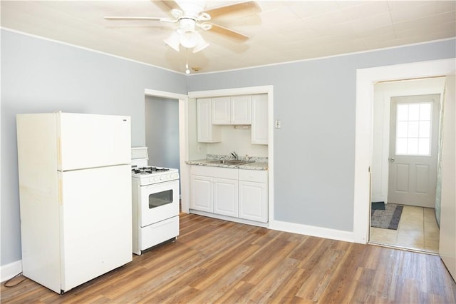 89 Warren Ave, East Providence, RI 02914 - kitchen with white appliances, a ceiling fan, white cabinetry, light wood-type flooring, and crown molding