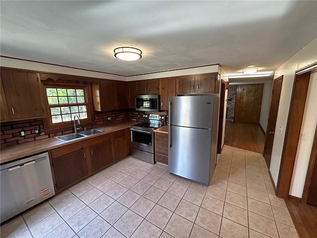 80 Silverwood Ln, West Warwick, RI 02893 - kitchen featuring appliances with stainless steel finishes, tasteful backsplash, light tile patterned flooring, and light countertops