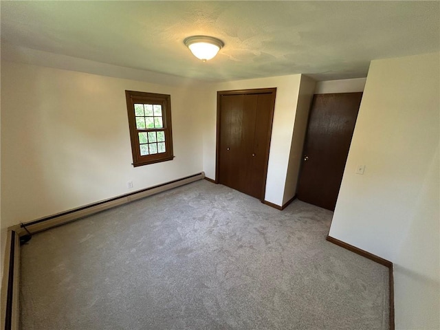 80 Silverwood Ln, West Warwick, RI 02893 - unfurnished bedroom with a baseboard radiator, carpet floors, and a closet