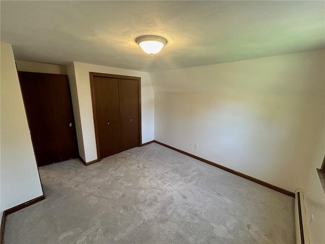 80 Silverwood Ln, West Warwick, RI 02893 - unfurnished bedroom featuring baseboard heating, carpet, and a closet