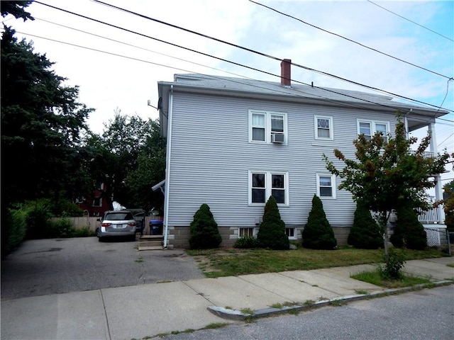 598 Admiral St, Providence, RI 02908 - view of home's exterior featuring a chimney and driveway