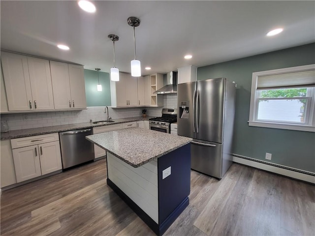 57 Merino St, Johnston, RI 02919 - kitchen featuring appliances with stainless steel finishes, wall chimney range hood, backsplash, dark wood-style floors, and a baseboard radiator