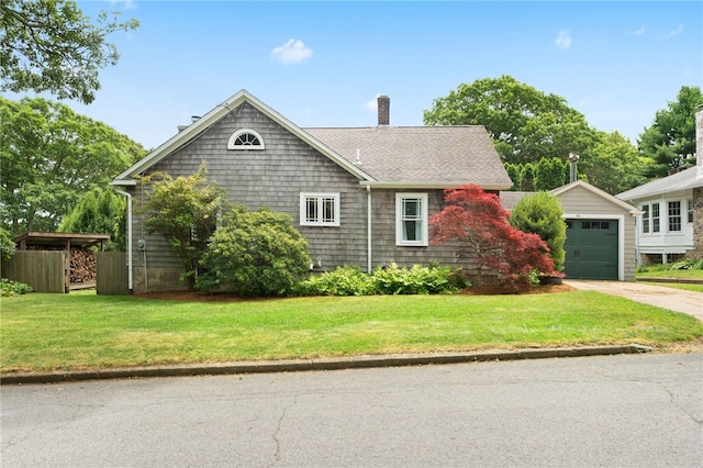 80 Highland Ave, South Kingstown, RI 02879 - view of front facade featuring a chimney, driveway, a front lawn, an outbuilding, and roof with shingles