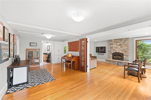 80 Highland Ave, South Kingstown, RI 02879 - living area with light wood-style floors and a stone fireplace