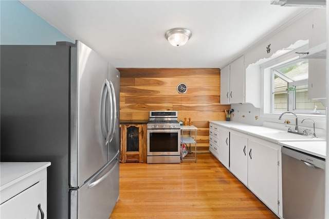 80 Highland Ave, South Kingstown, RI 02879 - kitchen with appliances with stainless steel finishes, light wood finished floors, white cabinets, and light countertops