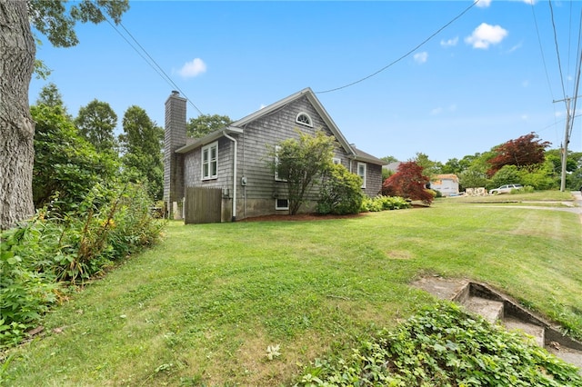 80 Highland Ave, South Kingstown, RI 02879 - view of side of home featuring a chimney and a yard
