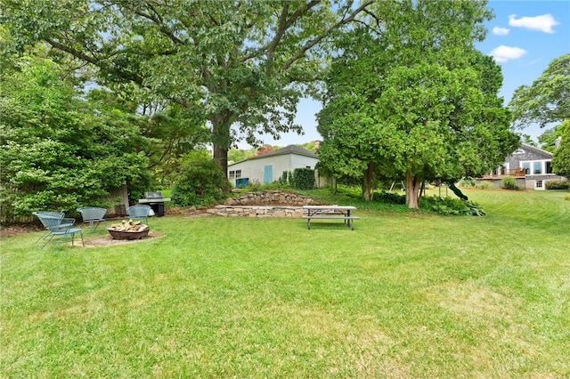 80 Highland Ave, South Kingstown, RI 02879 - view of grassy yard featuring an outdoor fire pit