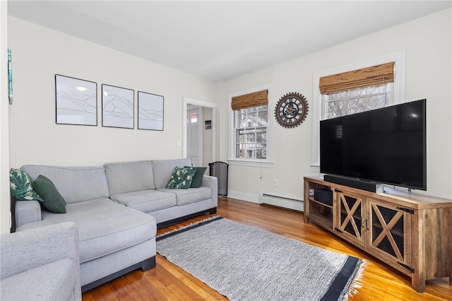 92 Franklin St, Bristol, RI 02809 - living area featuring a baseboard heating unit, plenty of natural light, and wood finished floors