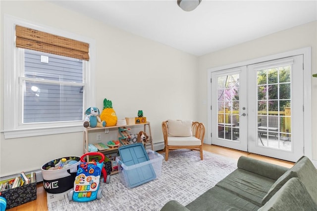 92 Franklin St, Bristol, RI 02809 - recreation room featuring french doors, wood finished floors, and a baseboard radiator