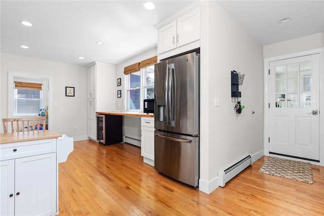 92 Franklin St, Bristol, RI 02809 - kitchen with stainless steel fridge with ice dispenser, baseboard heating, white cabinets, light wood-style floors, and recessed lighting