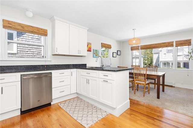 92 Franklin St, Bristol, RI 02809 - kitchen featuring dishwasher, a peninsula, light wood-style flooring, and white cabinetry