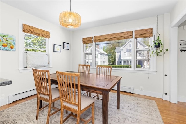 92 Franklin St, Bristol, RI 02809 - dining room with baseboard heating, healthy amount of natural light, and light wood-style flooring