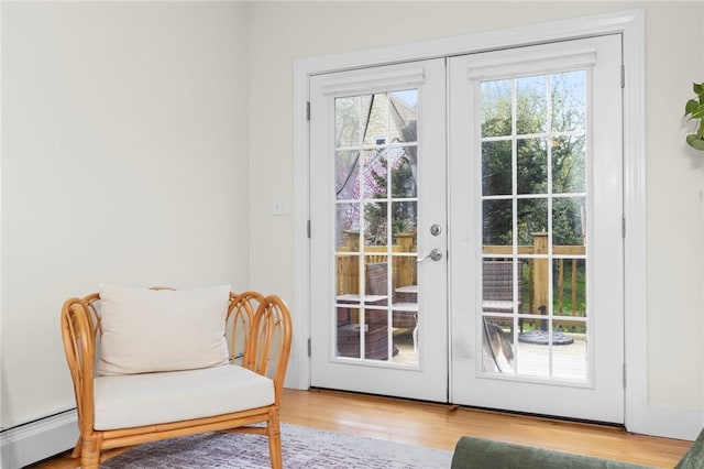 92 Franklin St, Bristol, RI 02809 - doorway with baseboard heating, french doors, and wood finished floors