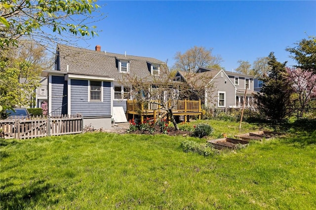 92 Franklin St, Bristol, RI 02809 - rear view of property featuring a deck, a chimney, a shingled roof, and a garden
