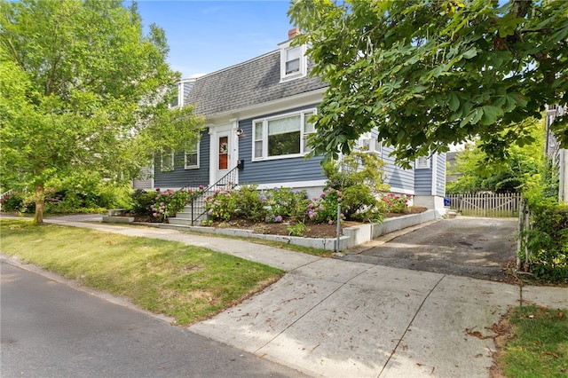 92 Franklin St, Bristol, RI 02809 - view of front facade with roof with shingles and driveway