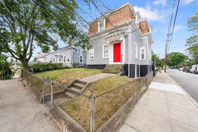 54 Harrison St, Pawtucket, RI 02860 - victorian home with entry steps, a fenced front yard, mansard roof, and a shingled roof