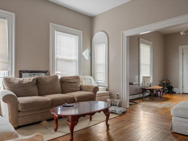 54 Harrison St, Pawtucket, RI 02860 - living room featuring baseboard heating and light wood-style floors