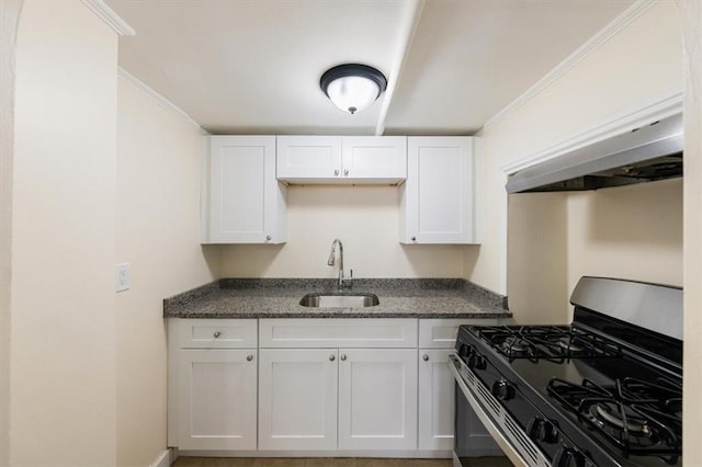 54 Harrison St, Pawtucket, RI 02860 - kitchen featuring stainless steel gas range oven, white cabinetry, ornamental molding, and dark stone countertops